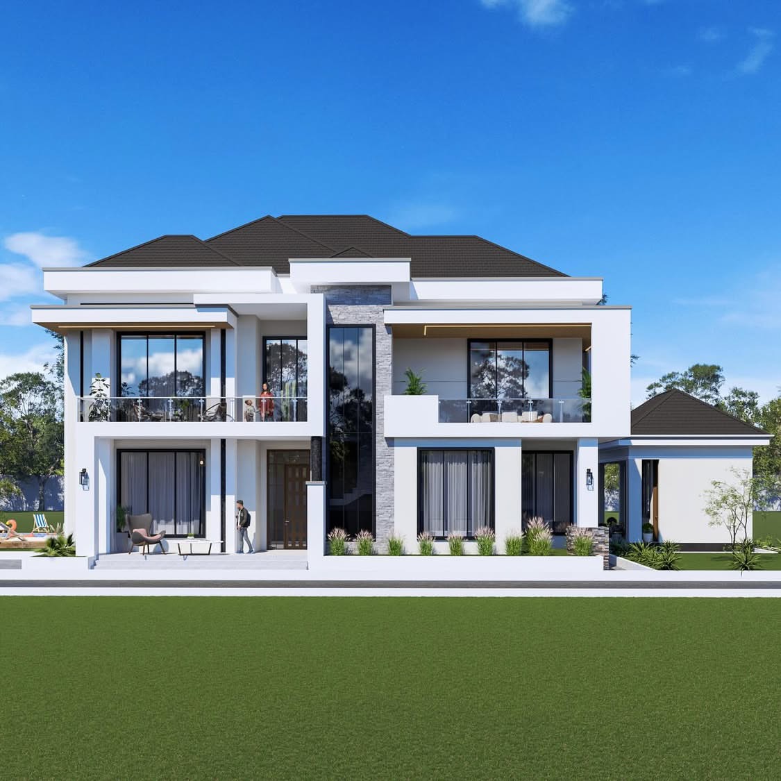White two-storey family house facing a large green lawn, with balconies, a stone feature wall, a pool terrace and people on the upper balcony